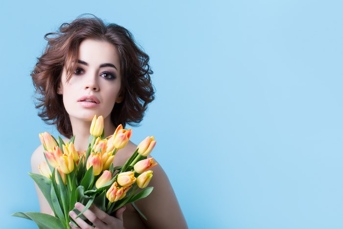 Model with Brown Hair Holding Tulips