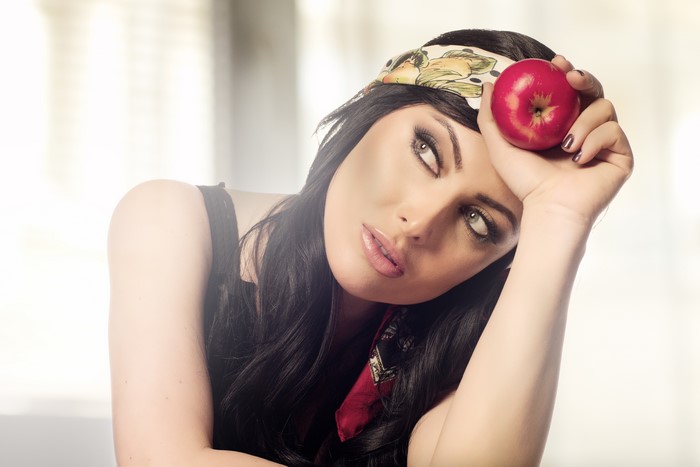 Brunette girl with apple and headband