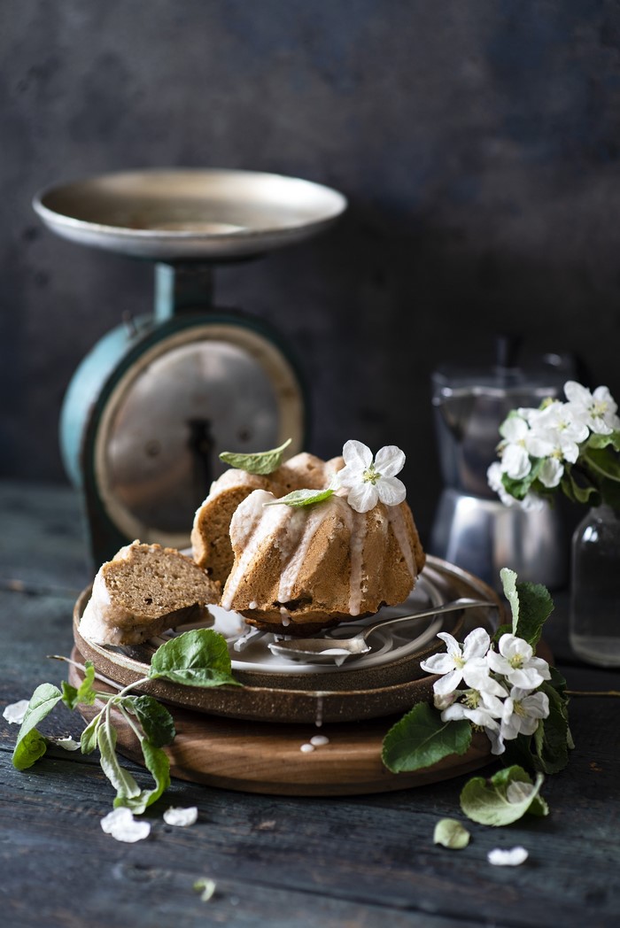 Bundt cake with icing and apple blossoms