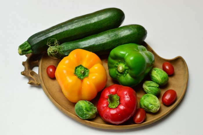 Assortment of fresh vegetables on a wooden platter