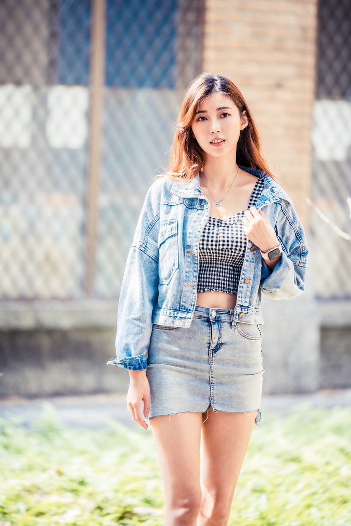 Asian Woman Wearing Denim Jacket and Skirt