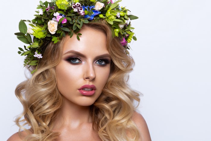 Beautiful blonde model with flower wreath and makeup