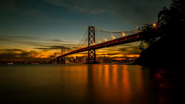 Bay Bridge at sunset with San Francisco skyline