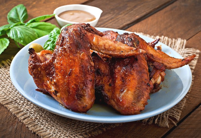 Roasted chicken wings on a plate with dipping sauce