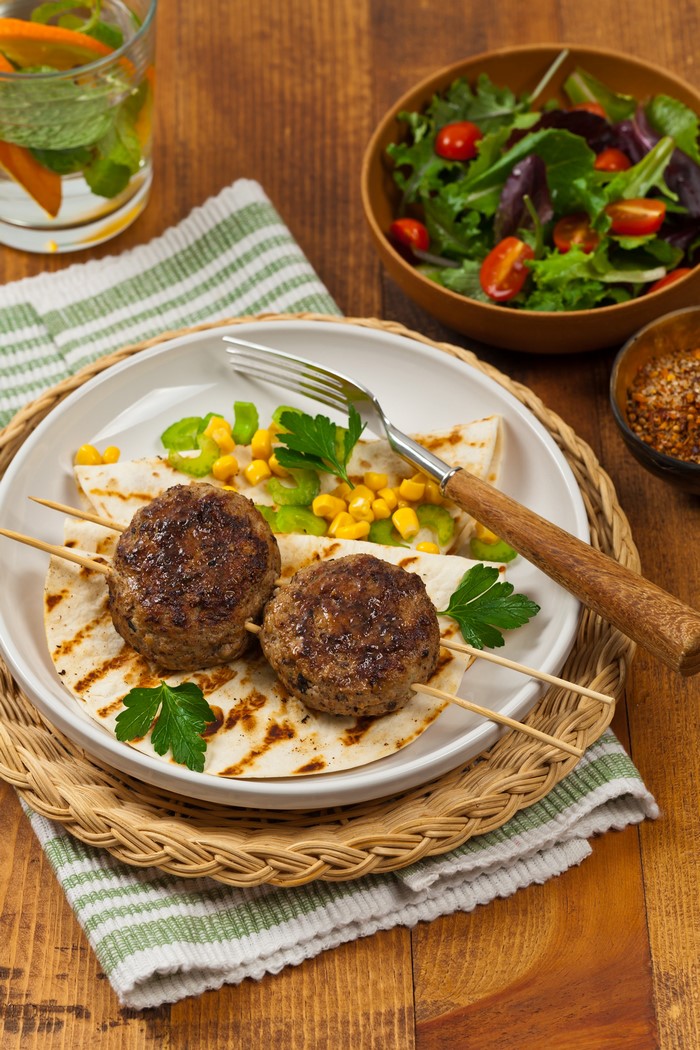 Frikadeller on flatbread with corn and salad
