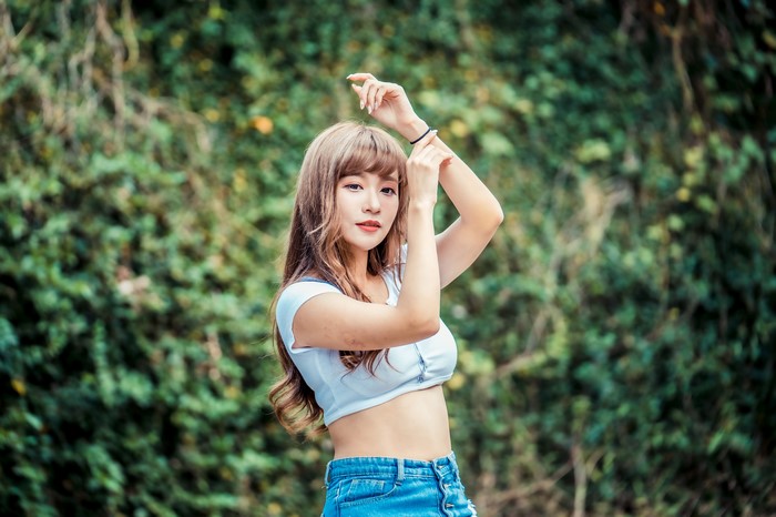 Asian woman posing with hands up