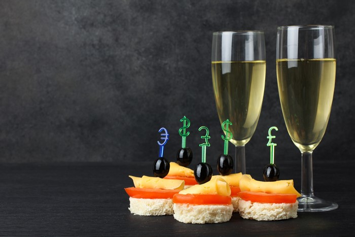 Appetizers with champagne and currency symbols