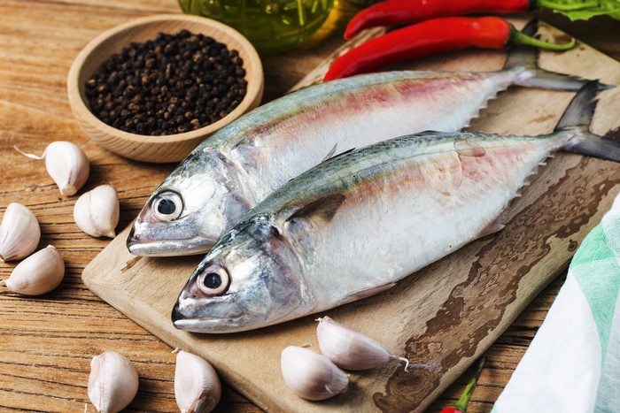 Two fresh fish with garlic, chili, and black pepper