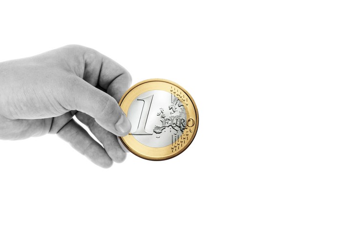 Hand holding a 1 Euro coin