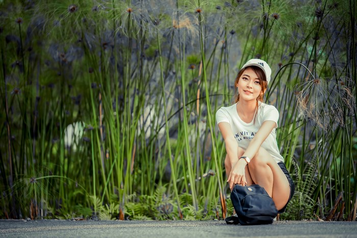 4K Asian Woman Sitting with Baseball Cap