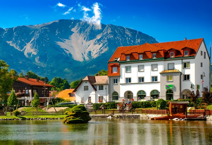 Houses and mountains by a lake in Puchberg am Schneeberg, Austria