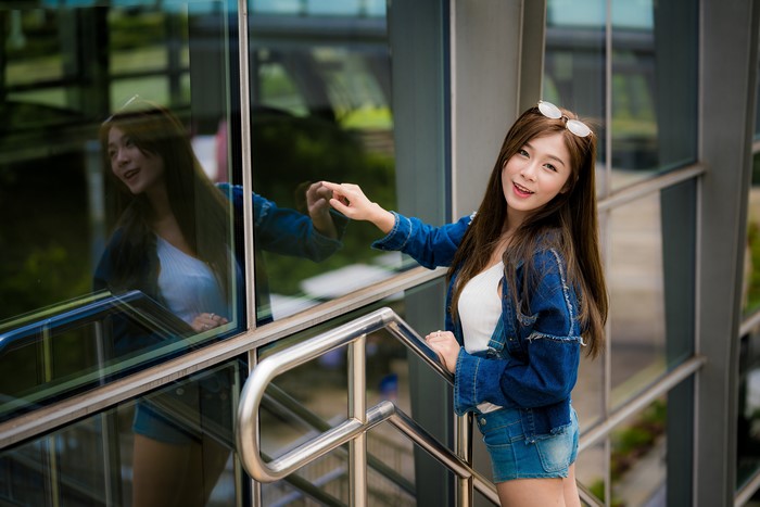 Asian woman in denim jacket and shorts