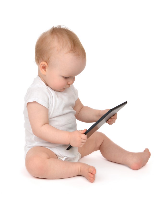 Baby sitting and playing with a tablet computer