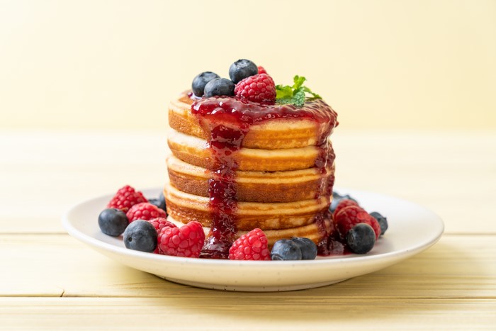 Pancakes with berries and jam on a plate