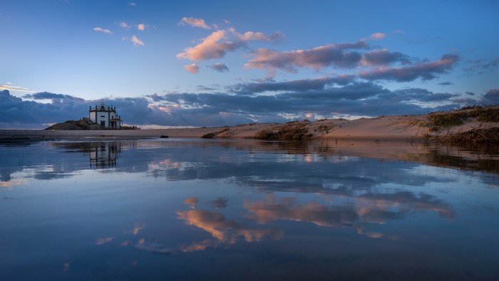 Capela do Senhor da Pedra church reflection at sunset, Portugal