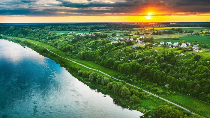 4K Lithuania: River, Houses, Fields at Sunset