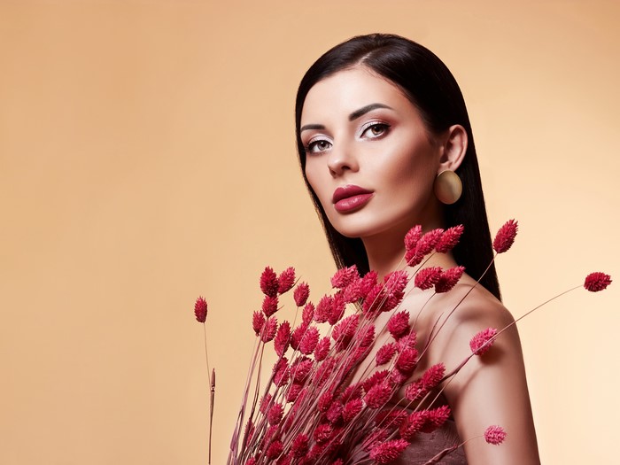 Model with red flowers and makeup