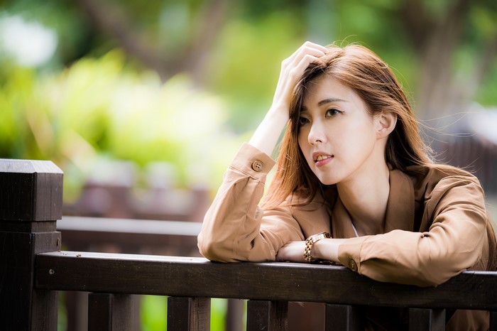 4K Asian Woman with Flowing Hair and Thoughtful Glance