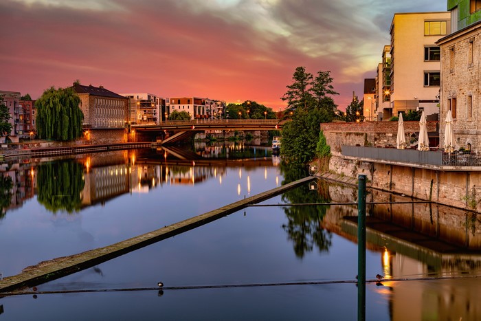Kassel, Germany at sunset with river and bridge