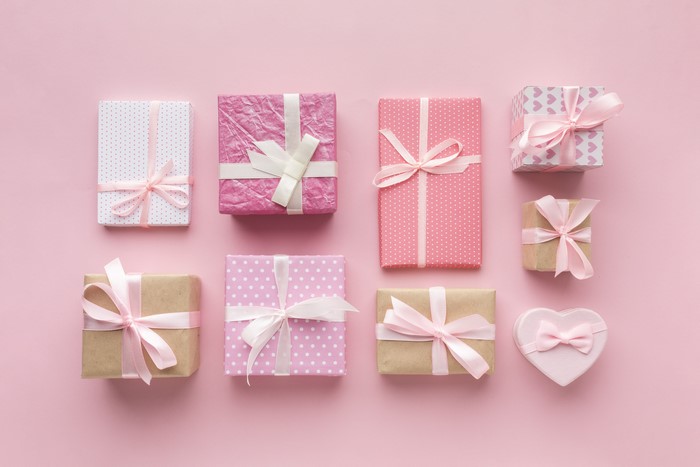Gifts with pink bows on pink background