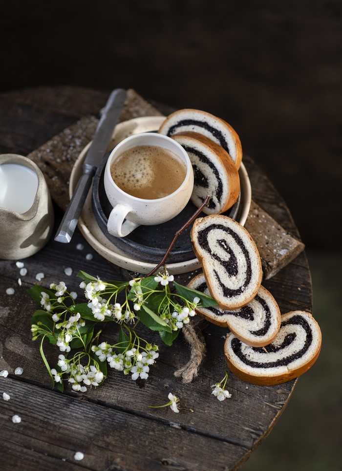 Coffee with poppy seed roll and flowers