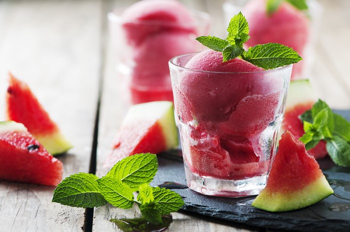 Watermelon sorbet in a glass with mint and watermelon pieces