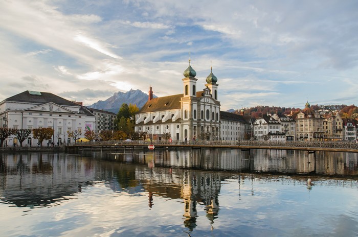 Jesuitenkirche and cityscape reflected in water, Luzern, Switzerland