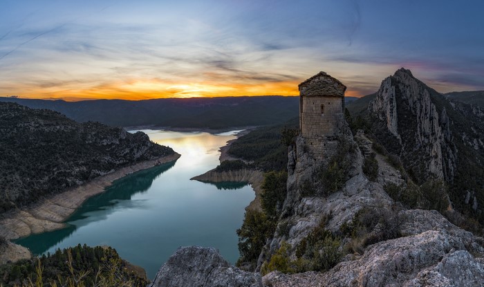 Mare de Deu de la Pertusa church on a crag at sunset, Catalonia