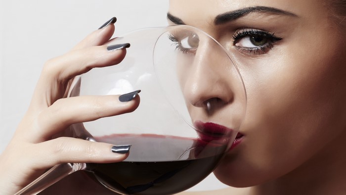 Woman drinking red wine from a glass