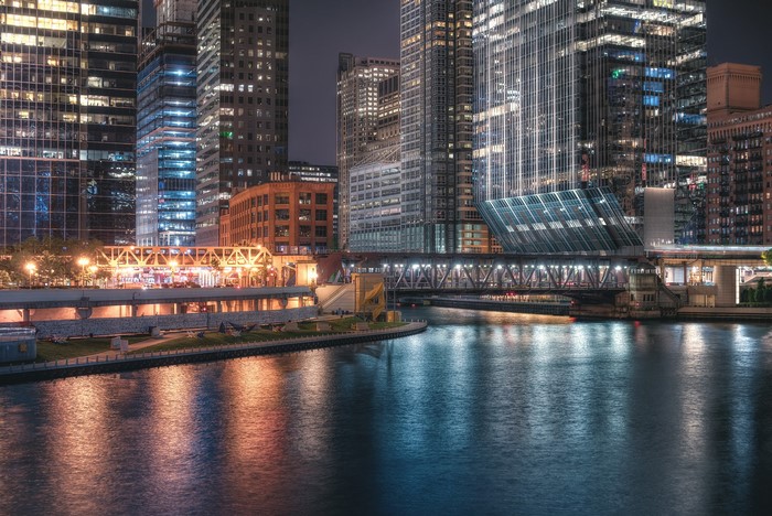 Chicago River at night with bridges and skyscrapers