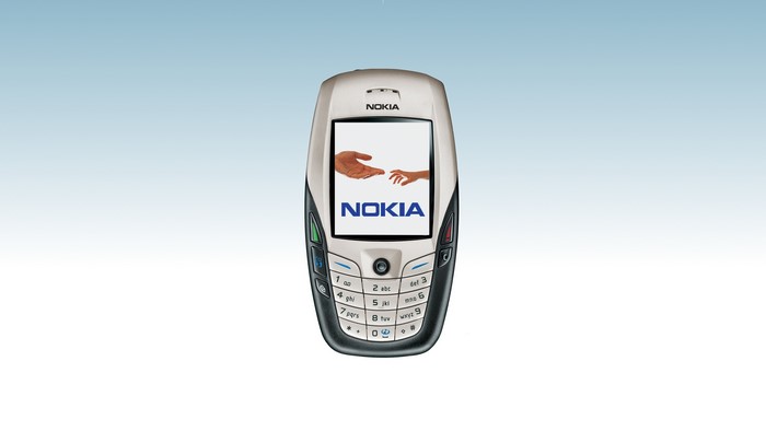 Nokia 6600 phone with hands reaching out on screen