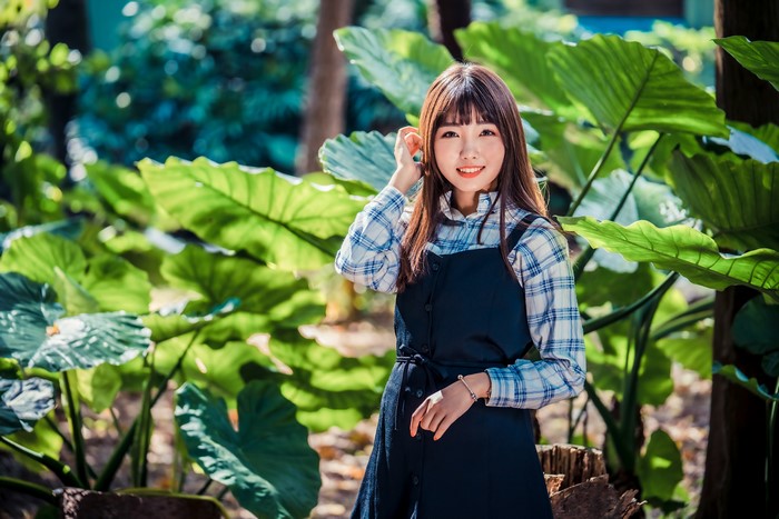 4K Asian Girl Smiling Among Green Leaves