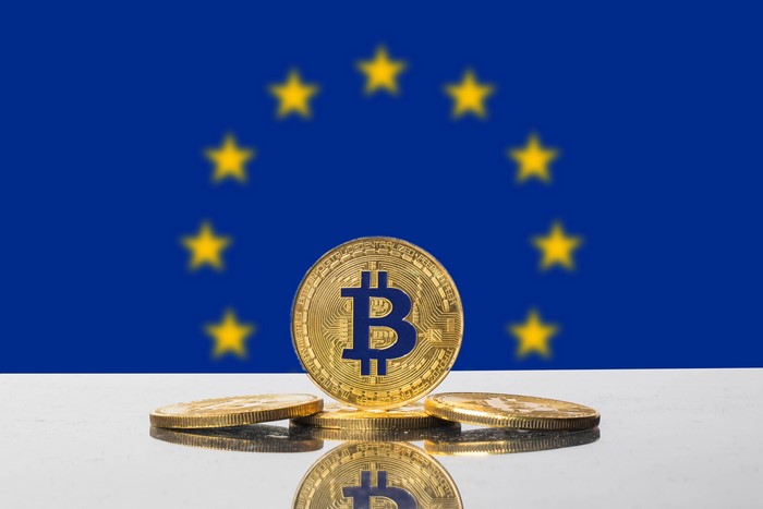 Bitcoin coins in front of the European Union flag