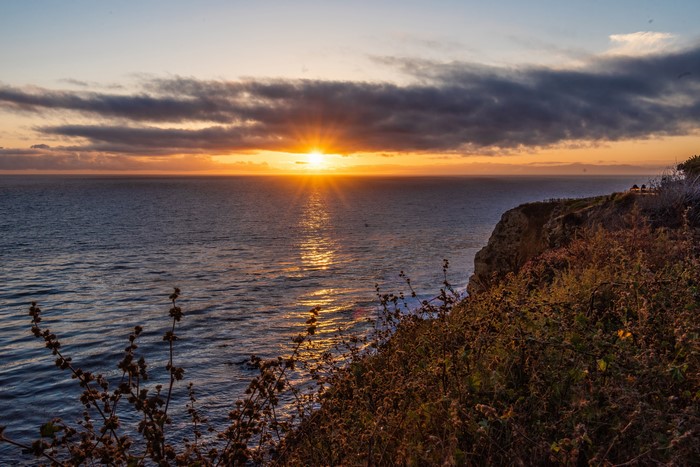 Sunset over the ocean from a cliff in California