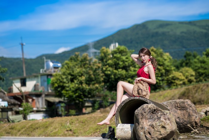 4K Beautiful Asian Woman Sitting on Stones