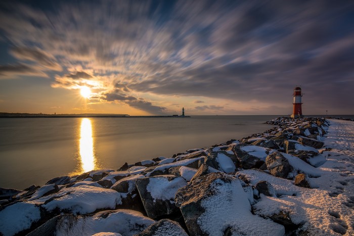 Lighthouse on a rocky coast at sunset, Germany