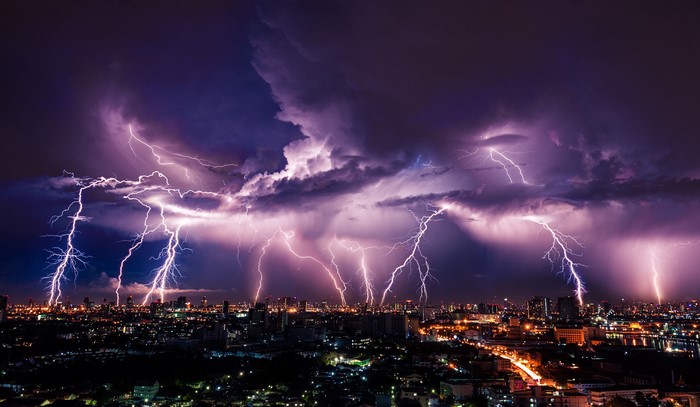 Lightning strikes over a city at night