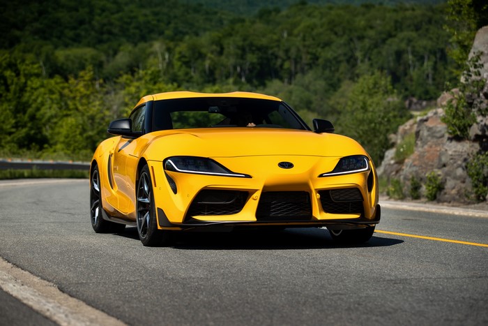 Yellow Toyota Supra GR A90 Coupe on a Road