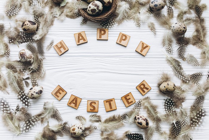 Easter greeting card with quail eggs and feathers