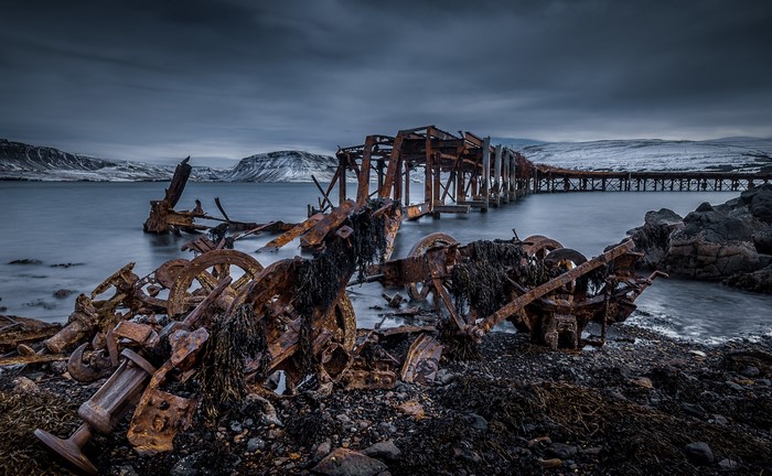 Rusty shipwreck and pier in Iceland