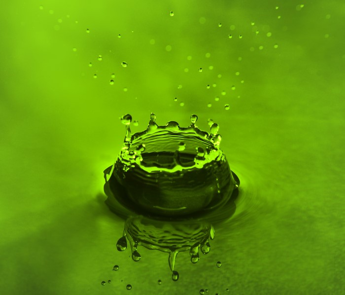 Green water splash with droplets