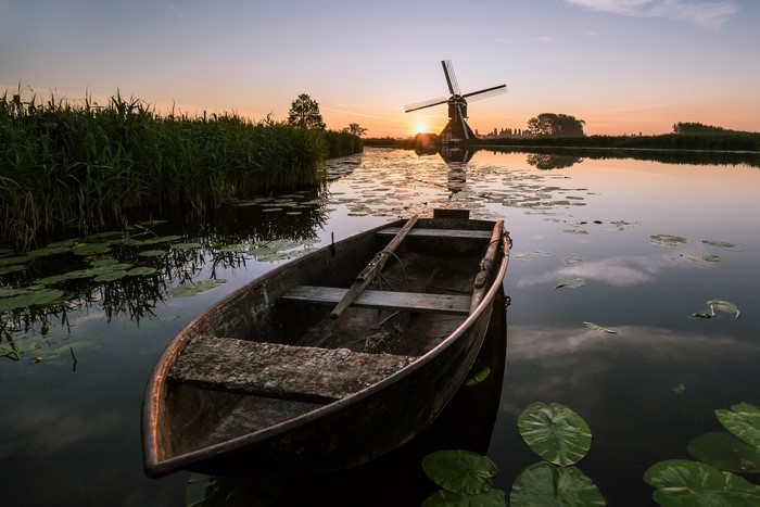 Boat on Canal with Windmill at Sunrise in Overslingeland, Netherlands