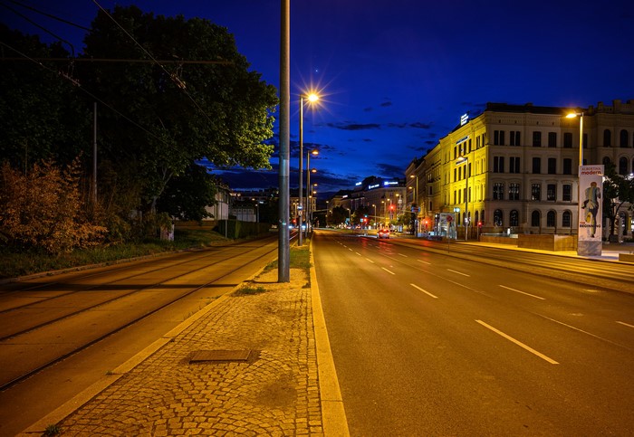 Vienna street at night with tram tracks and buildings