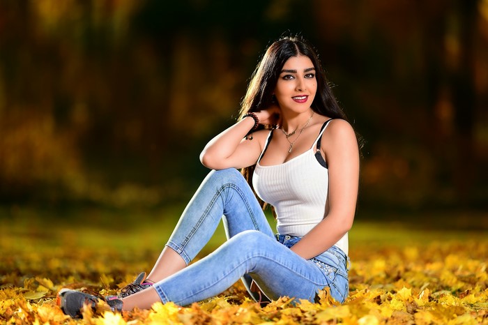 Anita sitting in autumn foliage