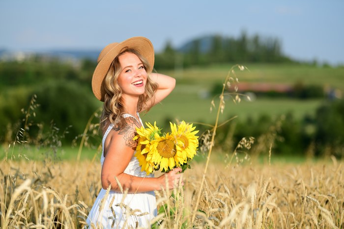 Selina in a field with sunflowers and wheat