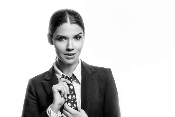 Karol, a model in a suit jacket and necktie
