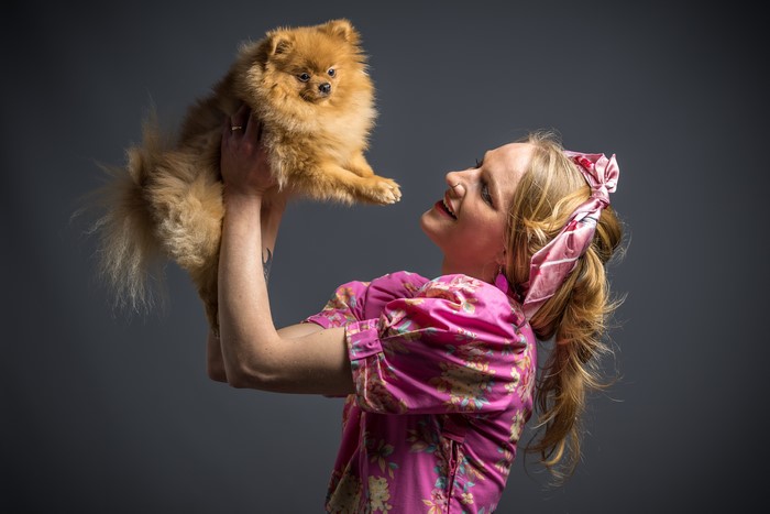 Woman holding a Pomeranian dog