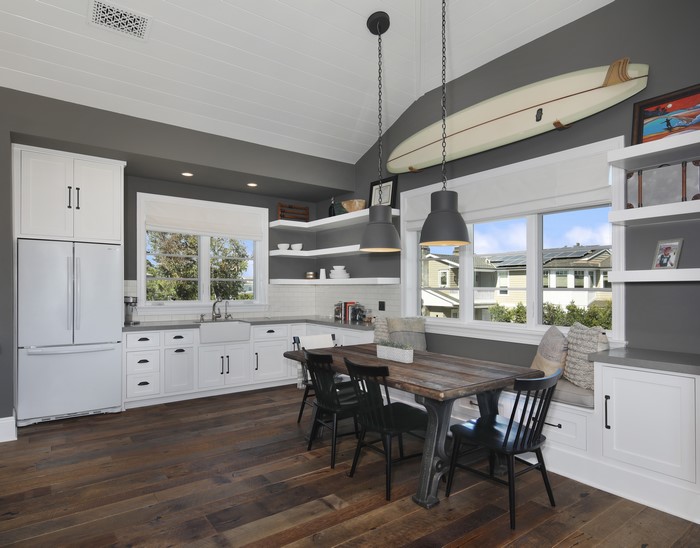 Kitchen with dining table and surfboard