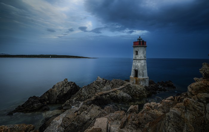 Lighthouse on rocky coast of Sardinia, Italy