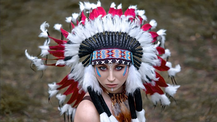 Woman wearing a Native American headdress